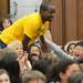 Logan Elementary School fifth-grade teacher Dante Watson runs up the aisle to join his fellow teachers in a flash mob dance performance during a year-end assembly on Friday morning. Melanie Maxwell I AnnArbor.com